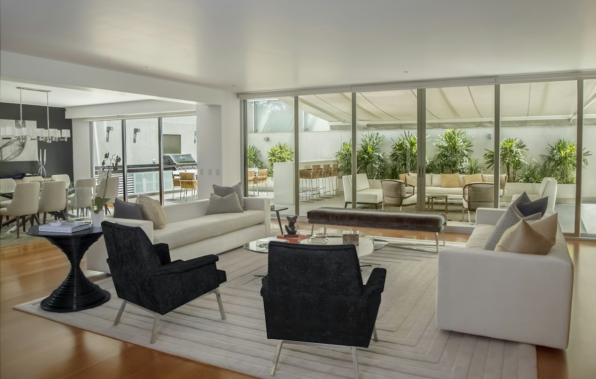 Upscale residential lounge with indoor-outdoor living, placeholder section imagery